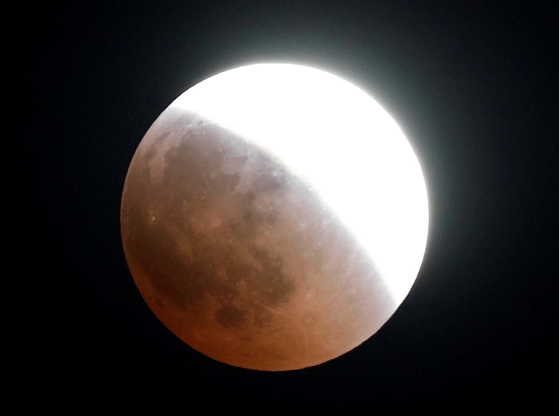 A "Super Blue Blood Moon" rises during a lunar eclipse over Cairo