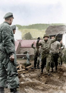 Batalla de las Ardenas. El Sturmbannführer Josef Diefenthal observa cómo los soldados estadounidenses del 119.º Regimiento de Infantería de EE. UU. , 30.º ID, se rinden en Stoumont, Bélgica, el 19 de diciembre de 1944.