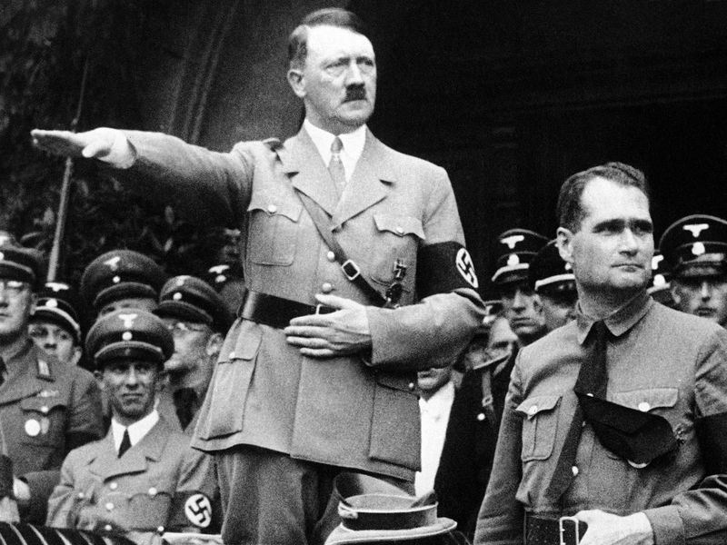 Adolf Hitler durante un desfile nazi. A su lado aparece su lugarteniente Rudolph Hess.