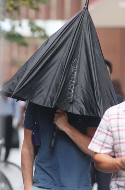Leo Hides Under Umbrella