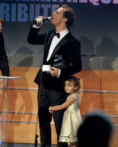 Matthew McConaughey casually accepting an award with his 4-year-old daughter Vida by his side in 2014